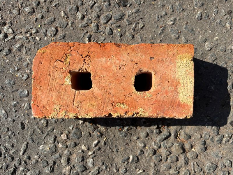 Reclaimed wire cut bricks with deep red to orange hues and textured finish
